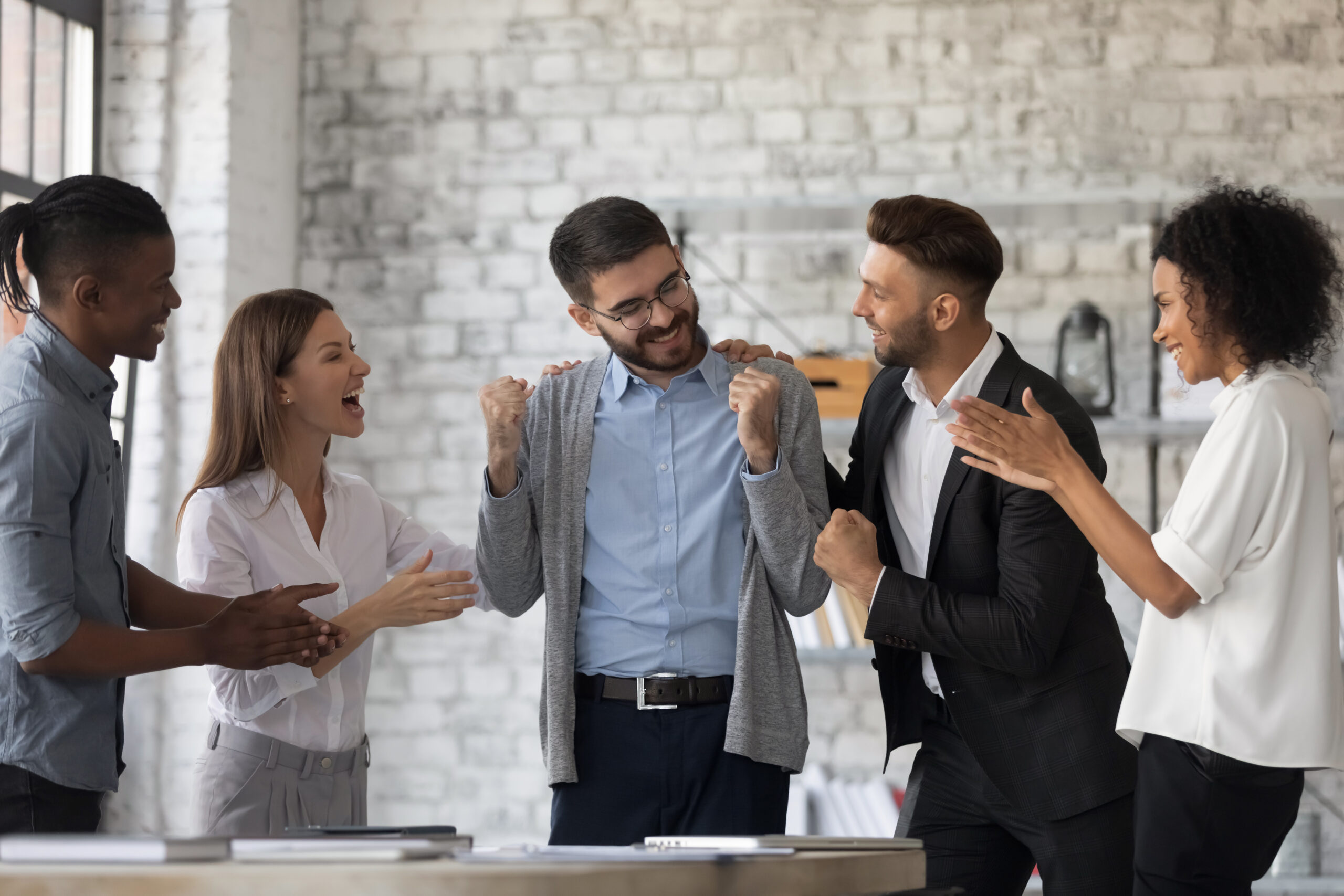 Smiling,Multiracial,Businesspeople,Congratulate,Colleague,With,Job,Success,Or,Achievement.